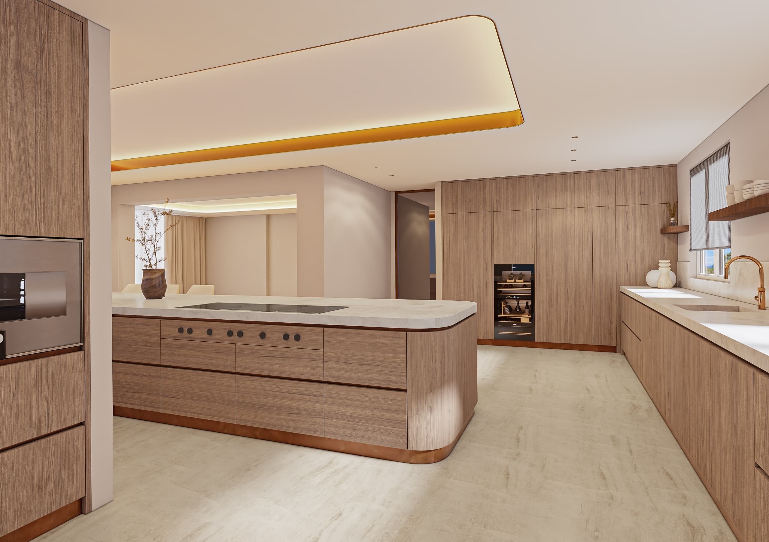 Kitchen at Soft Form Residence with rounded island, integrated cabinetry and concealed ceiling lighting